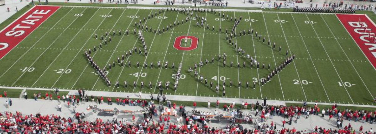 Ohio State band members forming the recycle symbol in the Ohio Stadium
