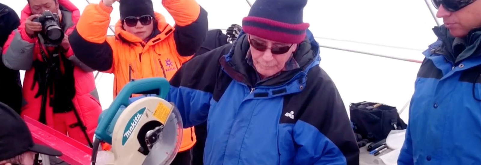 Lonnie Thompson cuts an ice core retrieved from the Guliya Ice Cap in the Kunlun Mountains in Tibet in 2015.