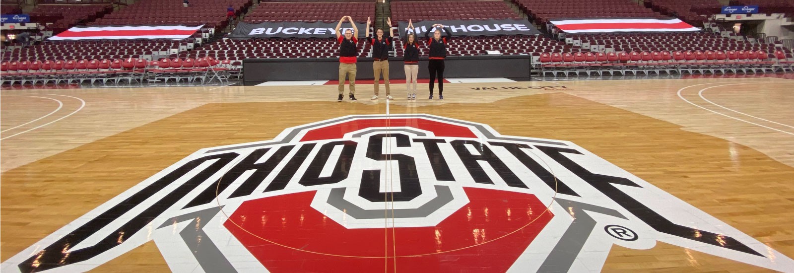 Zero waste interns spelling Ohio on Ohio State's basketball floor. 