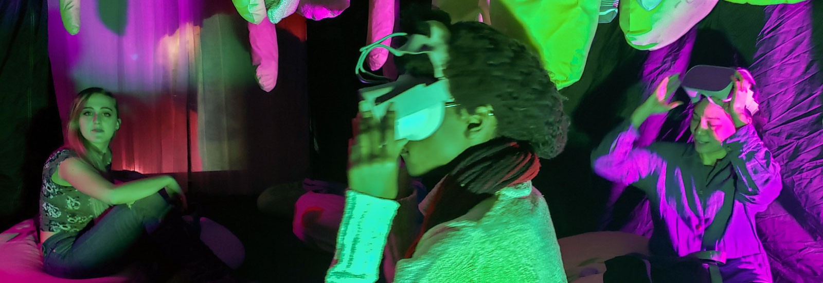 People sitting at the multimedia art installation, "Un-becoming Carbon," wear virtual reality goggles to see the vital relationship between plants and humans. 