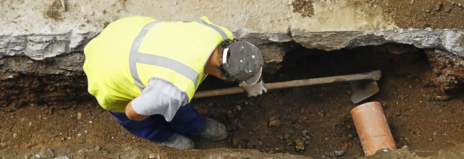 A man inspecting a sewer line. 