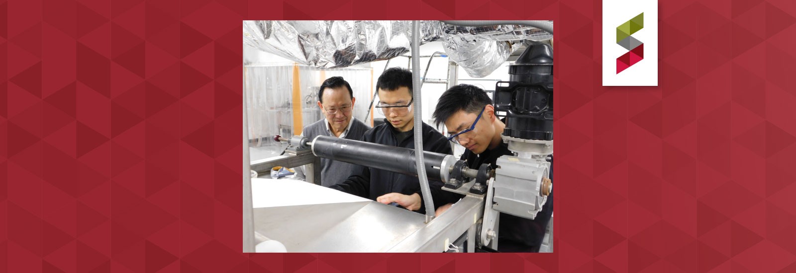 Winston Ho, graduate student Kai Chen, and Research Scientist Yang Han ('18 PhD) adjust the membrane substrate on Ho's membrane-manufacturing equipment in this photo from spring 2019.