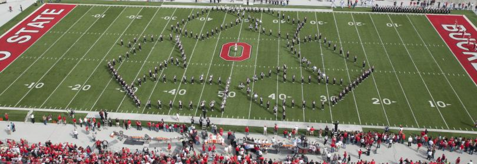Ohio State band members forming the recycle symbol in the Ohio Stadium