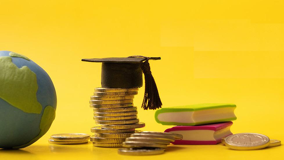 Coins with graduation cap and globe