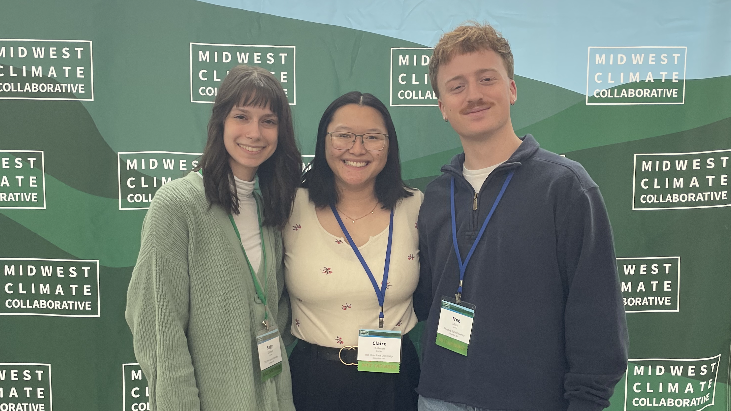Students in front of Midwest Climate Summit banner