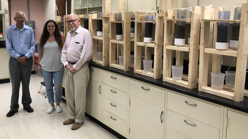 Student and faculty members with lab equipment
