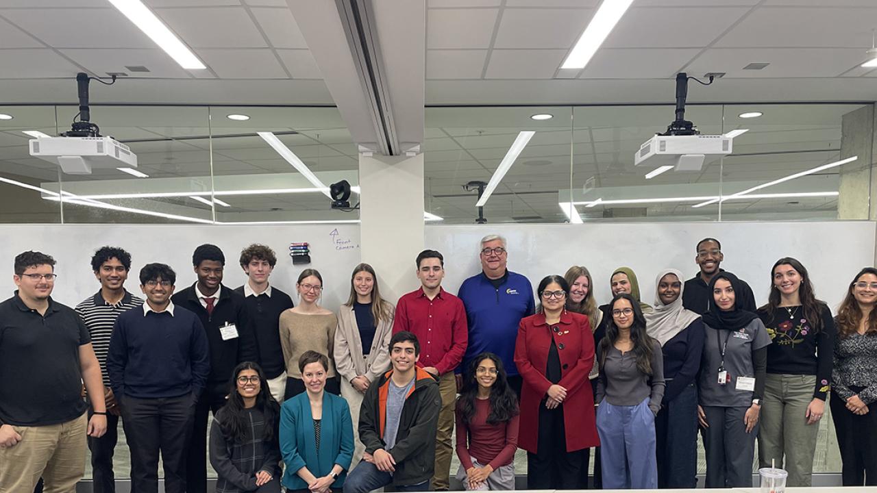 Students and SEA participants against a whiteboard 