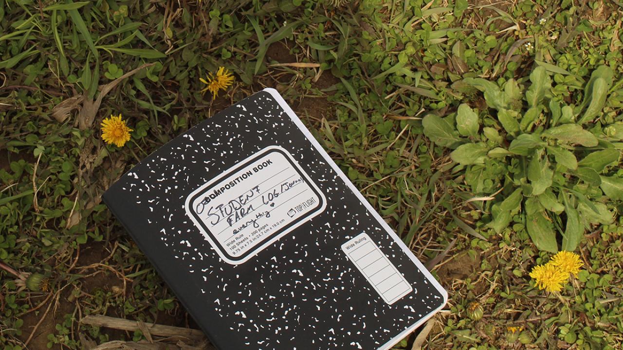 Student farm notebook on ground